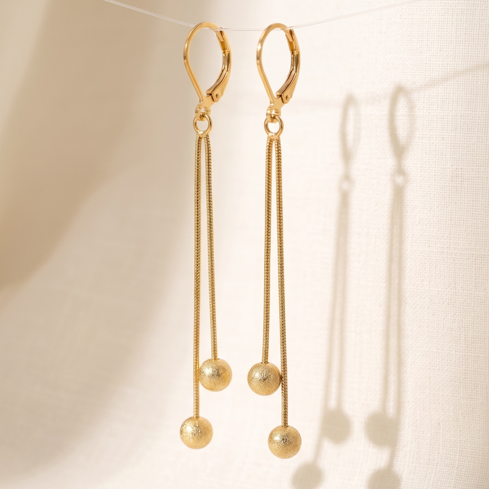 Sleek Motion: The Double-Sphere Chain Drop Earrings